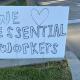 Home made Sign that says we love our essential workers. 